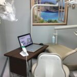 Dental chair with laptop and equipment